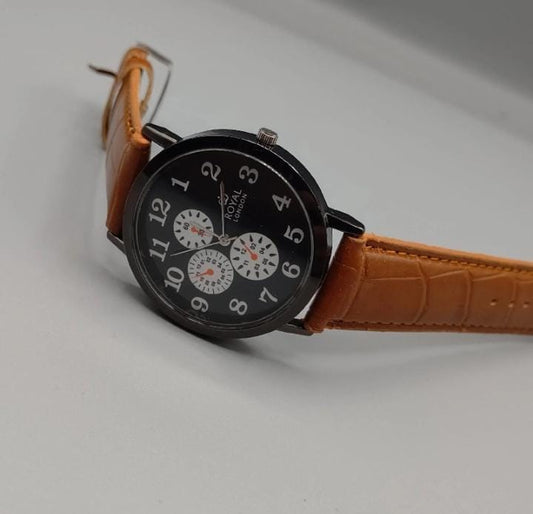 Watch with brown leather strap on a light gray background