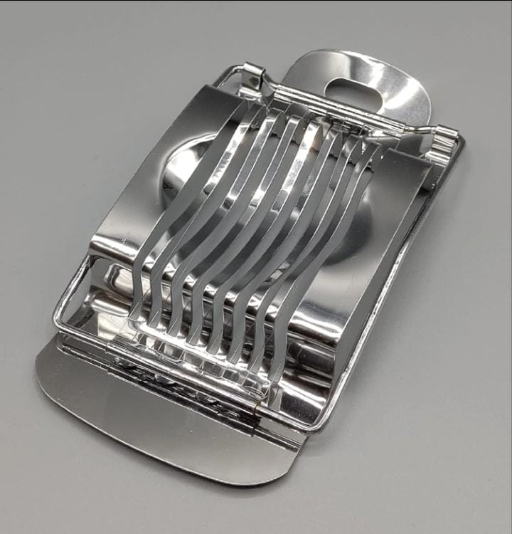 Metallic kitchen slicer on a gray background