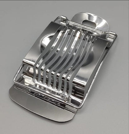 Metallic kitchen slicer on a gray background