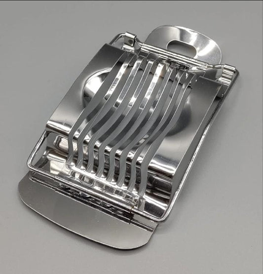 Metallic kitchen slicer on a gray background